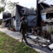 An Israeli soldier walking past destroyed houses in Kibbutz Beeri, Israel, October 2023