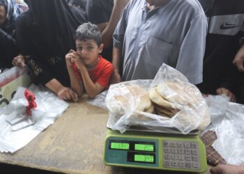 Palestinians wait to buy bread during the ongoing bombardment of the Gaza Strip in Rafah on Sunday, Oct. 29, 2023. (AP Photo/Hatem Ali)