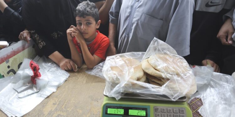 Palestinians wait to buy bread during the ongoing bombardment of the Gaza Strip in Rafah on Sunday, Oct. 29, 2023. (AP Photo/Hatem Ali)