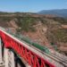 This aerial photo taken on Nov. 23, 2022 shows a Fuxing bullet train running on the Yuanjiang bridge of the China-Laos Railway in southwest China's Yunnan Province. (Xinhua/Hu Chao)