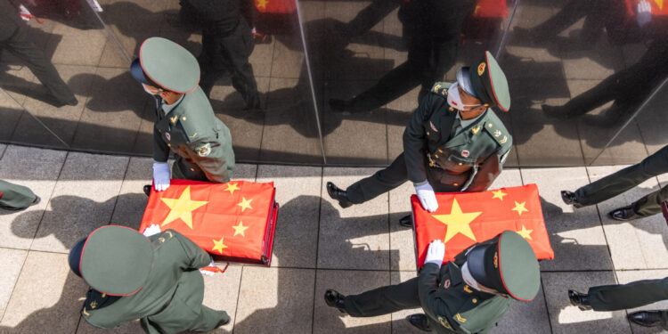 Coffins containing the remains of the Chinese People's Volunteers martyrs are escorted by soldiers during a burial ceremony at the CPV martyrs' cemetery in Shenyang, Northeast China's Liaoning province, Sept 17, 2022. [Photo by Chen Song/for chinadaily.com.cn]