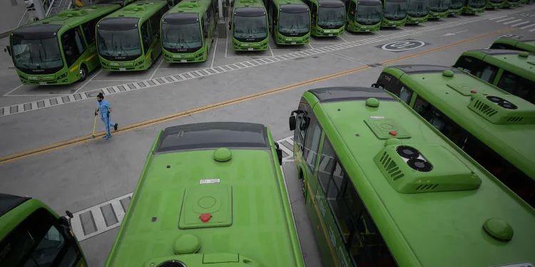 Electric public buses line a parking facility in Bogotá on Sept. 30, 2022. RAUL ARBOLEDA/AFP VIA GETTY IMAGES
