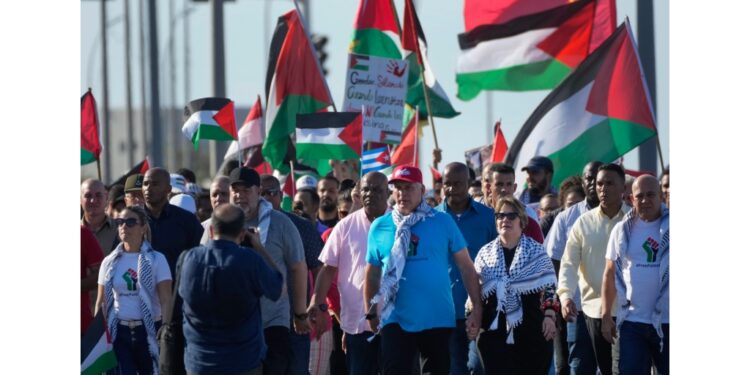 Cuban President Miguel Díaz-Canel, centre, and his wife Lis Cuesta march during a pro-Palestinian demonstration in Havana, Cuba, Thursday, November 23, 2023. (AP Photo/Ramon Espinosa)
