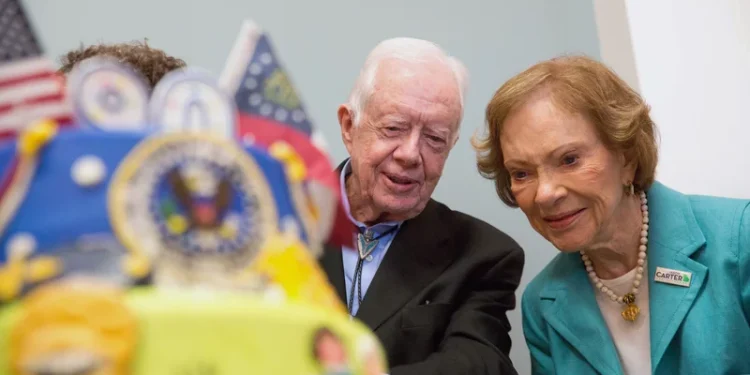 Former first lady Rosalynn Carter looks at a birthday cake with her husband, former President Jimmy Carter, during his 90th birthday celebration held at Georgia Southwestern University, Oct. 4, 2014, in Americus, Ga.