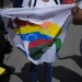 A woman holds a flag during a voting rehearsal for the upcoming December referendum for the territorial dispute between Venezuela and Guyana in Caracas Venezuela Saturday November 19, 2023 (AP Photo/ Ariana Cubillos)