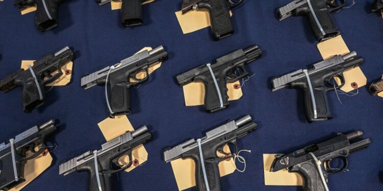 Guns seized in federal law enforcement actions are displayed during a press conference to announce a crackdown on firearms and ammunition smuggling to Haiti and the Caribbean at the Homeland Security Investigations offices in Miami, Florida on August 17, 2022. (Photo by Giorgio Viera / AFP) (Photo by GIORGIO VIERA/AFP via Getty Images)