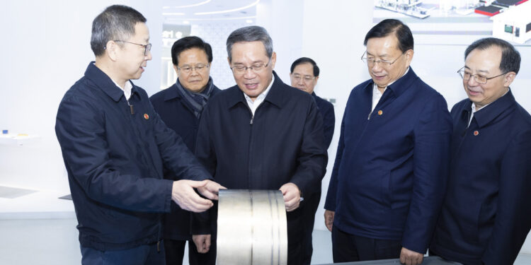 Premier Li Qiang, also a member of the Standing Committee of the Political Bureau of the Communist Party of China Central Committee, learns about development of the laser industry while visiting HGLaser Engineering Co., Ltd. in Wuhan, Central China's Hubei province, Jan 3, 2024. [Photo/Xinhua]