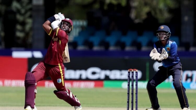 Steve Wedderburn goes aerial as wicketkeeper Sharujan Shanmuganathan looks on.