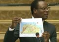 Foreign Affairs Minister Hugh Todd holding a map of northern South American that includes the internationally recognised boundary of Guyana  (Demerara Waves)