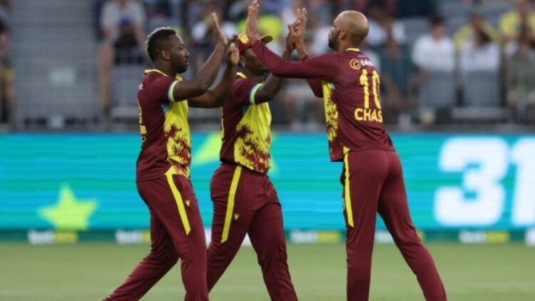 Andre Russell (left), Roston Chase (right) and Sherfane Rutherford celebrate a wicket.