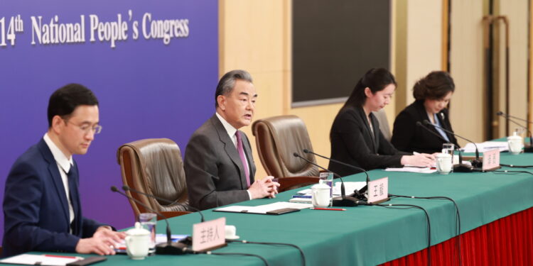 Foreign Minister Wang Yi (second from left) answers a question from the media on Thursday at a news conference in Beijing on the sidelines of the annual session of China's top legislature. FENG YONGBIN/CHINA DAILY
