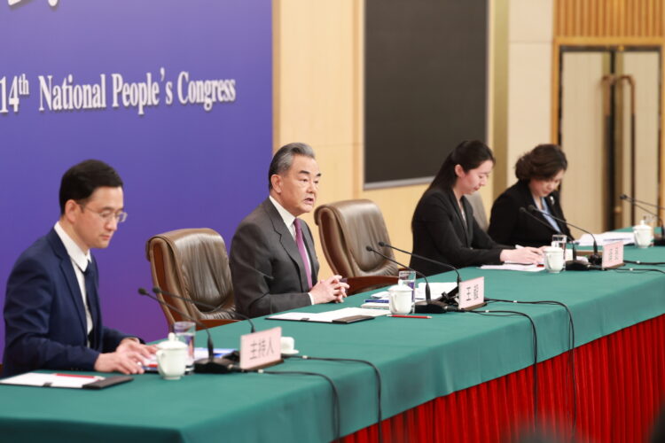 Foreign Minister Wang Yi (second from left) answers a question from the media on Thursday at a news conference in Beijing on the sidelines of the annual session of China's top legislature. FENG YONGBIN/CHINA DAILY