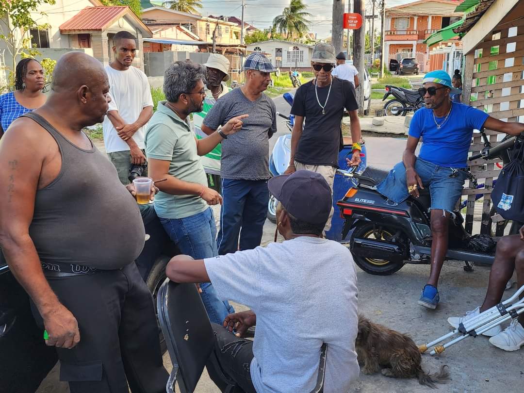 Former City Mayor Pt. Ubraj Narine (in green polo shirt) interacting with East Ruimveldt residents. March 10, 2024