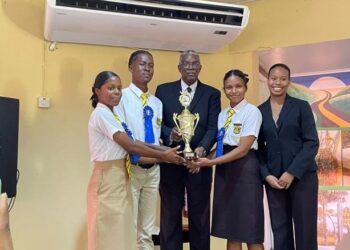 The winning team, Queen’s College, with Chief Justice (retd) Justice Kenneth Benjamin (centre), and Mia Barker, Treasurer for UGLS (far right).