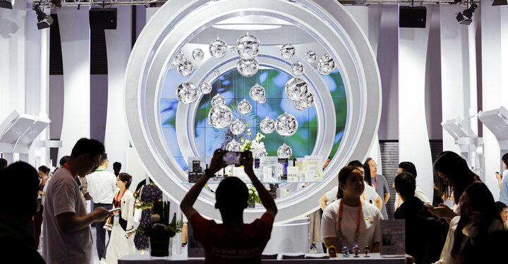 (240414) -- BEIJING, April 14, 2024 (Xinhua) -- People visit the fourth China International Consumer Products Expo in Haikou, capital city of south China's Hainan Province, April 13, 2024. China launched a series of global consumption events on Saturday at the fourth China International Consumer Products Expo in Haikou. Lasting from April 13 to 18, the expo will host over 4,000 brands from 71 countries and regions, which are expected to showcase their novel and upmarket products for global consumers, according to the organizer. (Xinhua/Tian Weiwei)