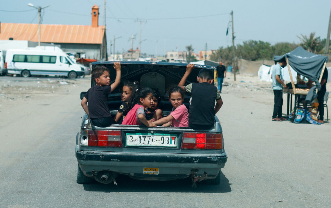 Children sit in a car trunk, amid the ongoing conflict between Israel and Hamas, in Rafah, in the southern Gaza Strip, April 24, 2024. REUTERS/Mohammed Salem