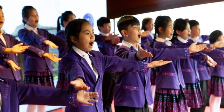 (240506) -- PARIS, May 6, 2024 (Xinhua) -- A choir consisting of children of Li and Miao ethnic groups from south China's Hainan Province performs during a Sino-French gastronomy festival aboard a boat along the Seine, in Paris, France, May 4, 2024. TO GO WITH "Feature: Gastronomy festival on Seine marks 60th anniversary of China-France ties" (Xinhua/Meng Dingbo)