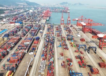 This aerial drone photo taken on May 9, 2024 shows containers being transported at the container terminal of Lianyungang Port, east China's Jiangsu Province. (Photo by Geng Yuhe/Xinhua)