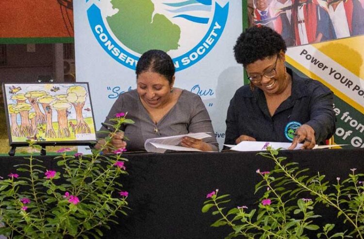 University of Guyana’s Vice-Chancellor, Professor Paloma Mohamed Martin (left) and Vice-Chairperson of the Guyana Marine Conservation Society (GMCS) Board of Directors, Dr. Arianne Harris signing the Memorandum of Understanding at UG’s Education Lecture Theatre.
