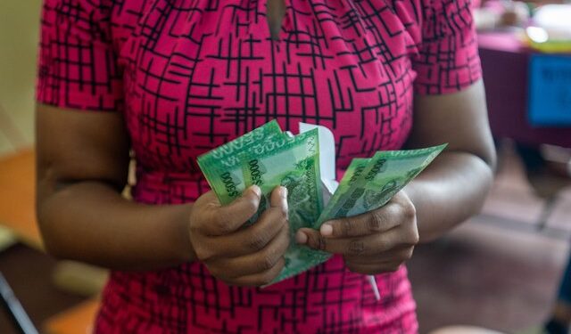 A parent who received the ‘Because We Care’ education cash grant