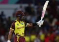 Shai Hope celebrates bringing up his fifty against the USA.