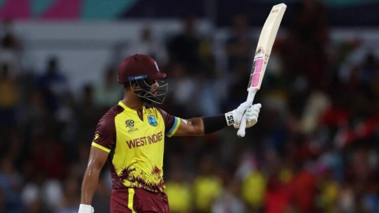 Shai Hope celebrates bringing up his fifty against the USA.