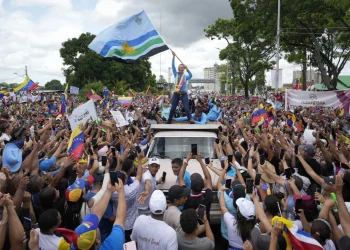 Opposition leader Maria Corina Machado waves a Monagas state flag as she greets supporters during a campaign rally for presidential candidate Edmundo Gonzalez, in Maturin, Venezuela, Saturday, July 20, 2024. The presidential election is set for July 28. (AP Photo/Matias Delacroix)