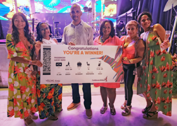 CEO Garvin Medera presents prizes of airline tickets to Puerto Rico - Caribbean Airlines’ newest destination to lucky patrons of Flavour and Flora