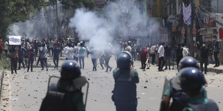 Students clash with riot police during a protest against a quota system for government jobs, in Dhaka, Bangladesh, Thursday, July 18, 2024. (AP Photo/Rajib Dhar)