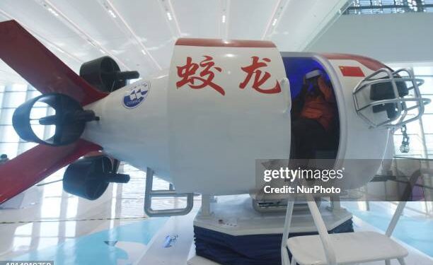 Visitors are using VR technology to experience deep-sea exploration in the ''Jiaolong Manned Submersible'' at the 2023 Zhejiang International Intelligent Transportation Industry Expo in Hangzhou, Zhejiang Province, China, on December 1, 2023. (Photo by Costfoto/NurPhoto via Getty Images)