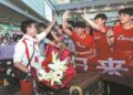 Diver Wang Zongyuan (left), who won gold with teammate Long Daoyi in the men's synchronized 3-meter springboard event and silver in the men's individual 3m springboard at the Paris Olympics, greets well-wishers on Monday at Beijing Capital International Airport. (Photo provided to China Daily)
