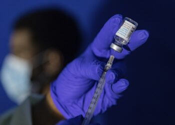 FILE - Family nurse practitioner Carol Ramsubhag-Carela prepares a syringe with the Mpox vaccine before inoculating a patient at a vaccinations site on, August 30, 2022, in the Brooklyn borough of New York. (AP Photo/Jeenah Moon, File)