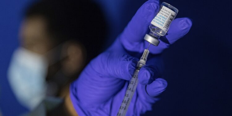 FILE - Family nurse practitioner Carol Ramsubhag-Carela prepares a syringe with the Mpox vaccine before inoculating a patient at a vaccinations site on, August 30, 2022, in the Brooklyn borough of New York. (AP Photo/Jeenah Moon, File)