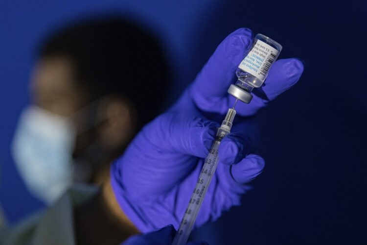 FILE - Family nurse practitioner Carol Ramsubhag-Carela prepares a syringe with the Mpox vaccine before inoculating a patient at a vaccinations site on, August 30, 2022, in the Brooklyn borough of New York. (AP Photo/Jeenah Moon, File)