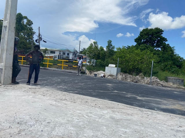 Construction workers see today, August 14, 2024 doing work on the Cemetery Road. The road is not opened to vehicular traffic contrary to Minister Edghill promise it will be "fully completed" by Monday, August 12, 2024