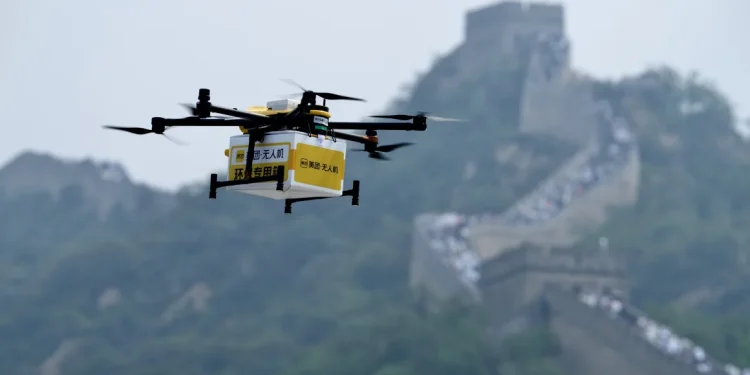 A drone carries a package from Chinese food delivery giant Meituan to the Badaling section of the Great Wall in Beijing, China, on August 16, 2024. Huang Liang/Beijing Youth Daily/VCG/Getty Images