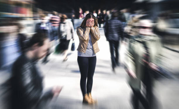 Panic attack in public place. Woman having panic disorder in city. Psychology, solitude, fear or mental health problems concept. Depressed sad person surrounded by people walking in busy street. (Google photo)