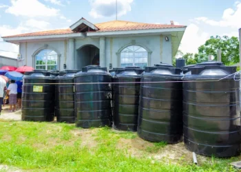 A number of black tanks were distributed to households in the Dr. Charles Housing Scheme for water storage (DPI photo)
