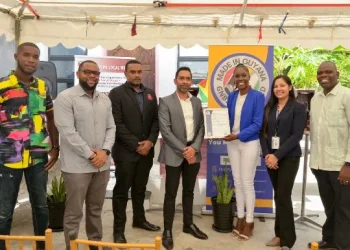 3. From the right, Communications Officer of MINTIC, Cordell McClure, GNBS Technical Officer, Rosmarie Liliah, Proprietress of Propa GT Local Wine, Abigale John eagerly displaying GNBS Made in Guyana Certificate, GNBS’ Executive Director, Trevor Bassoo, GNBS Head of Certification Services (Ag.), Keon Rankin and Kevon John
