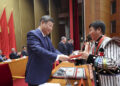 President Xi Jinping presents an award to a role model for ethnic unity and progress at a commendation ceremony in Beijing on Friday. JU PENG/XINHUA