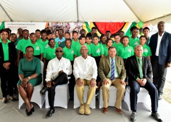 Flashback March 2019 photo. Students of the now defunct Bertram Collins College (background). Foreground are then President David Granger (seated, centre) is flanked by, from left to right, seated, Minister of Education, Ms. Nicolette Henry; Minister of Foreign Affairs, Mr. Carl Greenidge; Minister of Indigenous Peoples’ Affairs, Mr. Sydney Allicock and Minister of Social Cohesion, Dr. George Norton.