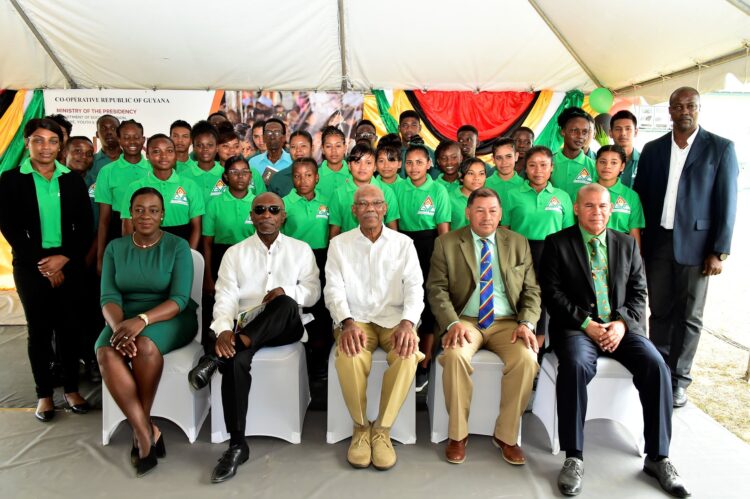 Flashback March 2019 photo. Students of the now defunct Bertram Collins College (background). Foreground are then President David Granger (seated, centre) is flanked by, from left to right, seated, Minister of Education, Ms. Nicolette Henry; Minister of Foreign Affairs, Mr. Carl Greenidge; Minister of Indigenous Peoples’ Affairs, Mr. Sydney Allicock and Minister of Social Cohesion, Dr. George Norton.