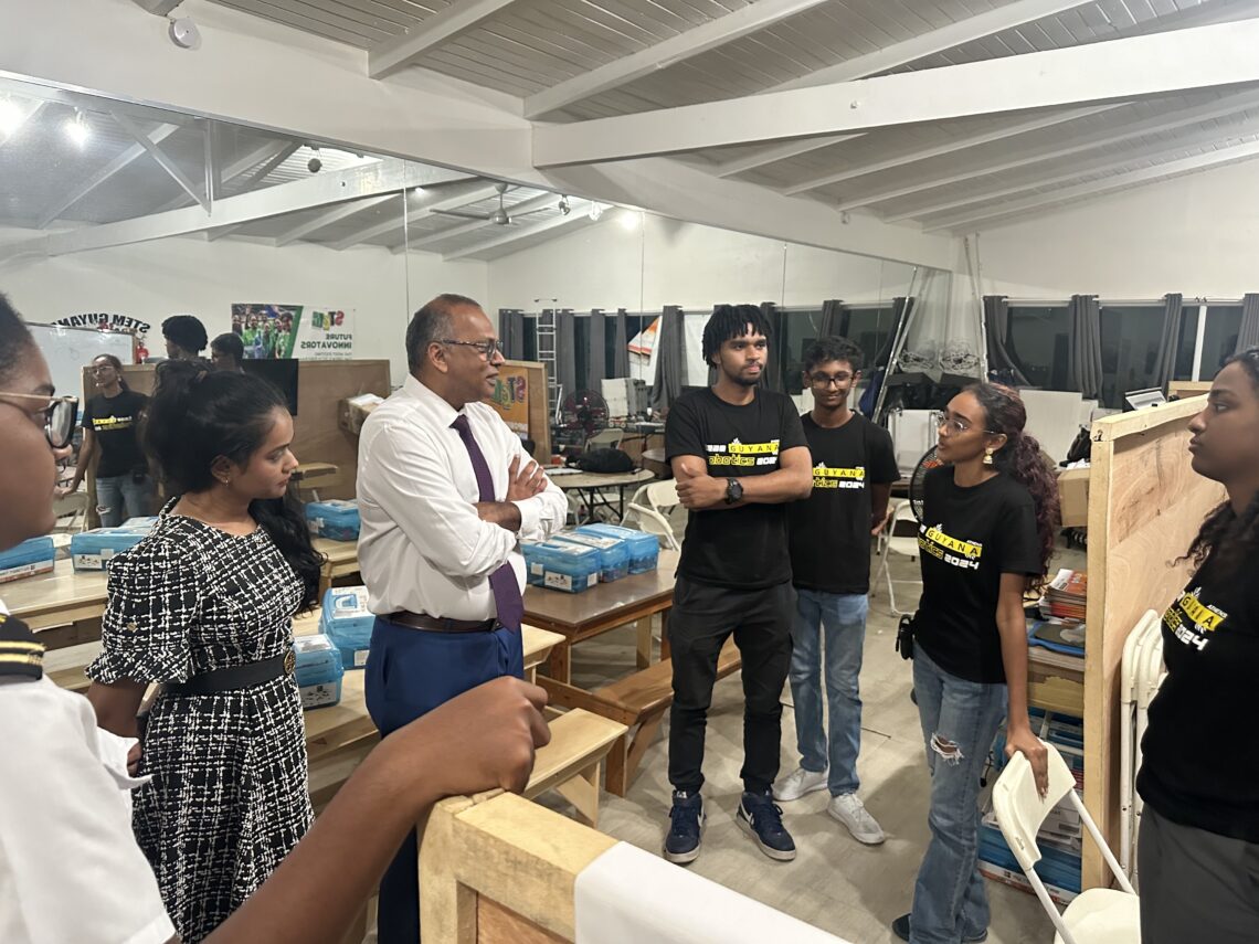 Minister Frank Anthony (centre) interacting with STEMGuyana team