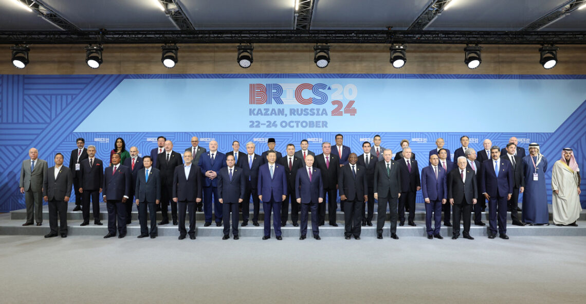 President Xi Jinping (front row, sixth from left), Russian President Vladimir Putin (front, sixth from right), leaders and representatives of other BRICS countries and guest countries, and heads of international organizations pose on Thursday for a group photo during the BRICS Plus leaders' dialogue in Kazan, Russia. YAO DAWEI/XINHUA