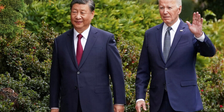 U.S. President Joe Biden waves as he walks with Chinese President Xi Jinping at Filoli estate on the sidelines of the Asia-Pacific Economic Cooperation (APEC) summit, in Woodside, California, U.S., November 15, 2023. REUTERS/Kevin Lamarque/File Photo Purchase Licensing Rights