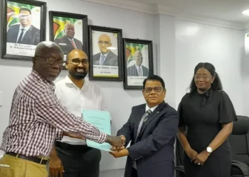 From left are Norris Witter (President, GWU); Dhaneshwar Deonarine (CLO); Deonarain Seepaul (Finance Director) and Kavorn Kyte-Williams (HR Chief Executive/General Counsel) Banks DIH Limited, after the signing of the MoA. (Banks DIH photo)