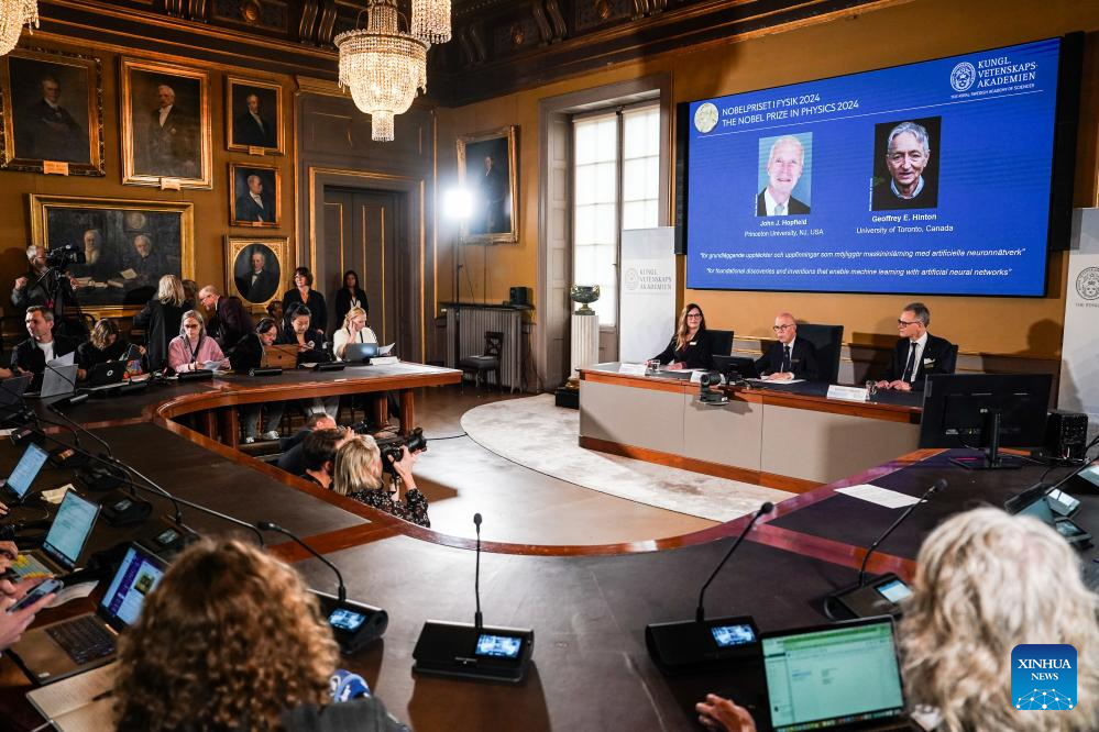 The 2024 Nobel Prize in Physics is announced in Stockholm, Sweden, Oct 8, 2024. The 2024 Nobel Prize in Physics went to two scientists, John J Hopfield and Geoffrey E Hinton, for foundational discoveries and inventions that enable machine learning with artificial neural networks, the Royal Swedish Academy of Sciences said on Tuesday. [Photo/Xinhua]