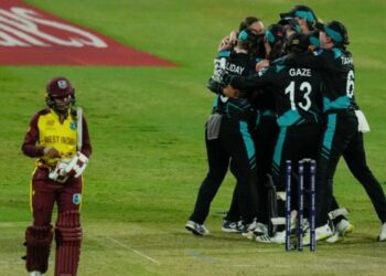 Afy Fletcher walks off as New Zealand players celebrate their win over the West Indies in the second semi-final at the ICC Women's T20 World Cup in Sharjah on Friday. (AP)