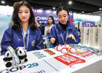 Staff display souvenirs on Monday at the China Pavilion of the 29th session of the Conference of the Parties to the United Nations Framework Convention on Climate Change, or COP29, in Baku, Azerbaijan. DOMINIKA ZARZYCKA/GETTY IMAGES