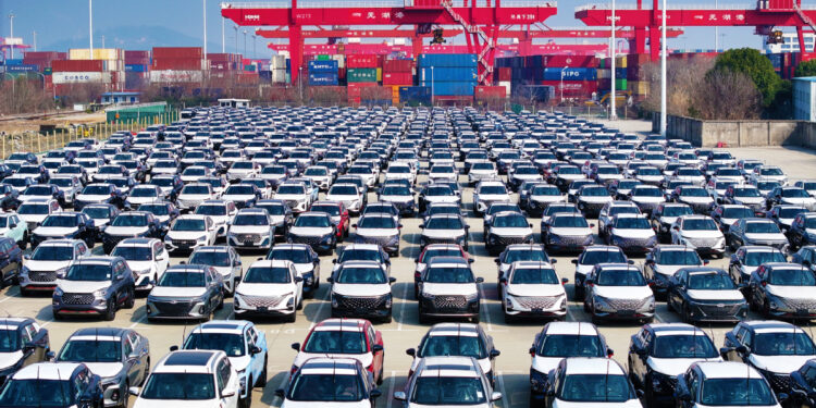 Hundreds of vehicles manufactured by Chery line up at a port of Wuhu, Anhui province, awaiting export. [WANG YUSHI/FOR CHINA DAILY]